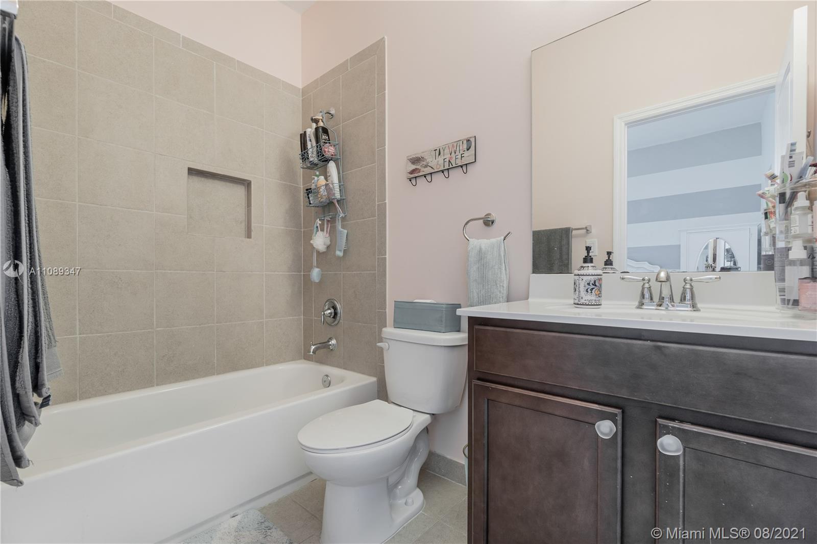 12119 Southwest 253rd Street Homestead, FL 33032 - Photo 33 of 46 a bathroom with a sink a toilet and a bathtub