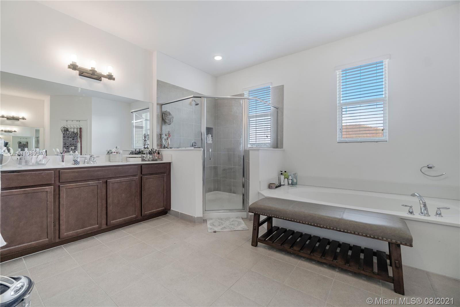 12119 Southwest 253rd Street Homestead, FL 33032 - Photo 37 of 46 a spacious bathroom with a double vanity sink and a mirror