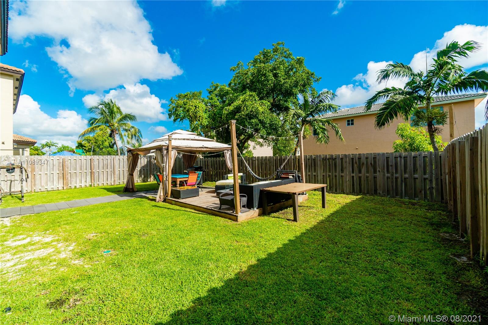 12119 Southwest 253rd Street Homestead, FL 33032 - Photo 42 of 46 a view of a house with backyard porch and sitting area