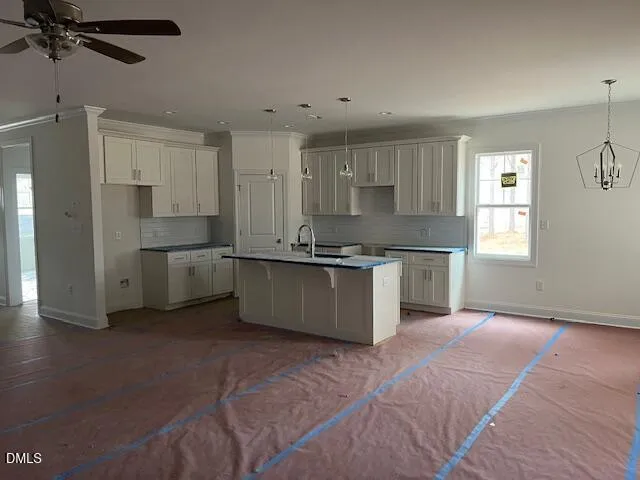 a large kitchen with stainless steel appliances kitchen island granite countertop a stove a sink dishwasher and a refrigerator