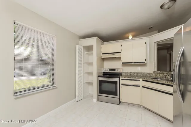 a kitchen with stainless steel appliances granite countertop a stove and a refrigerator