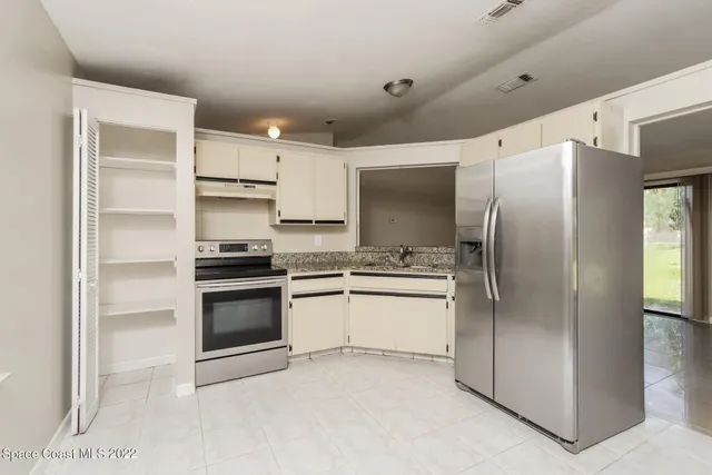 a kitchen with stainless steel appliances a refrigerator sink and stove