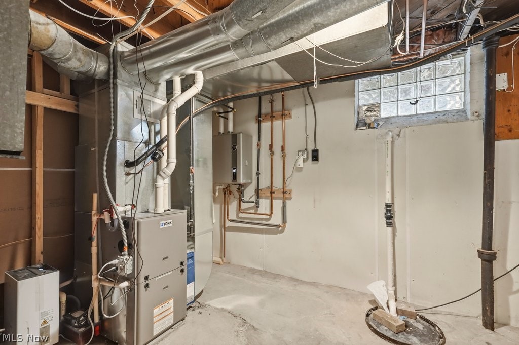 1379 Winston Road South Euclid, OH 44121 - Photo 25 of 30 Basement with furnace, tankless water heater, sump pump and laundry hook ups.