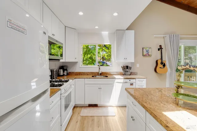 a bedroom with a bed and a view of kitchen