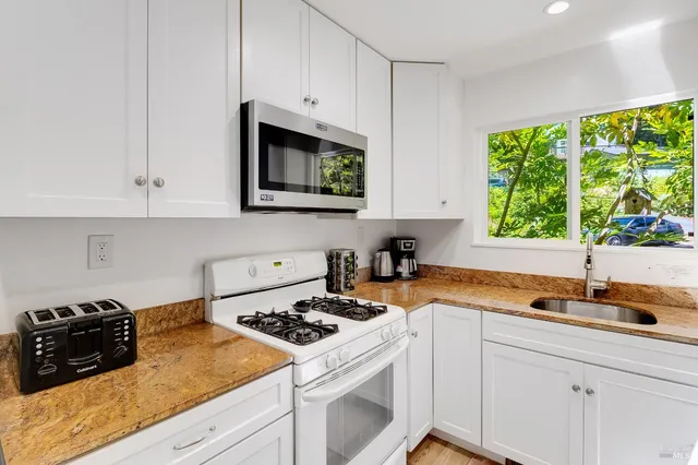 a bedroom with a bed and a view of kitchen