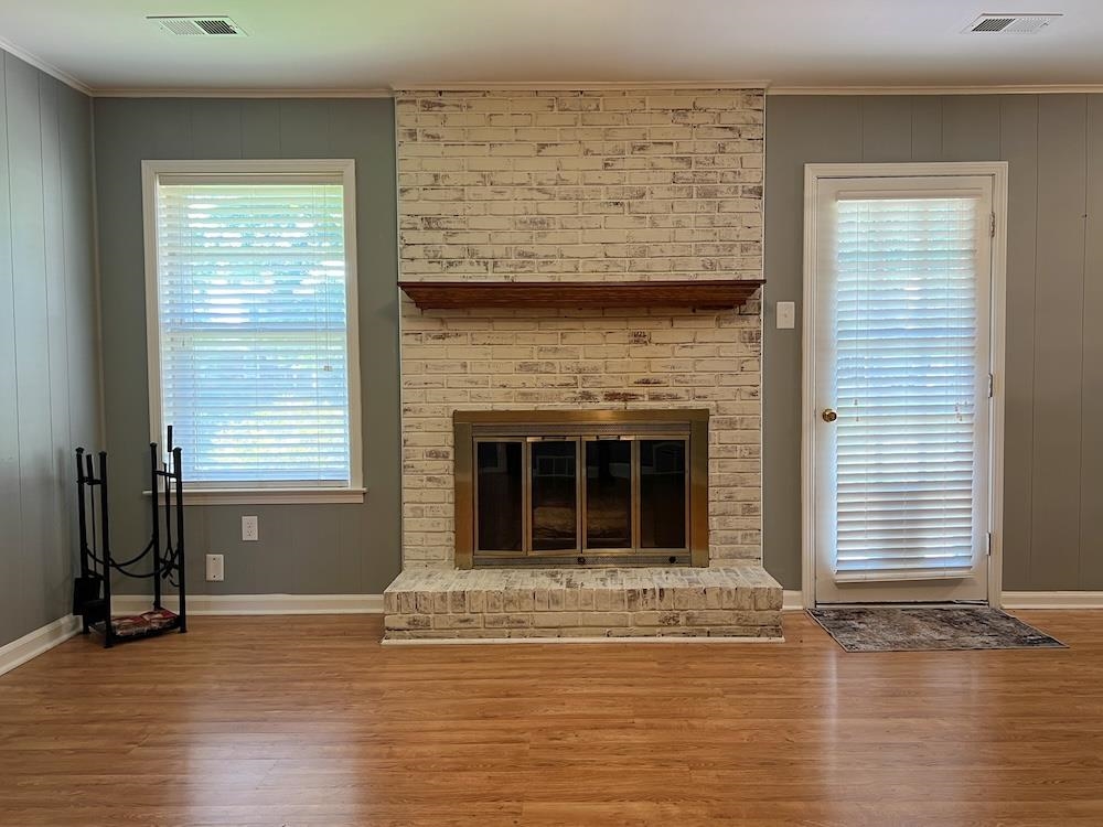 7935 Memphis Arlington Road Bartlett, TN 38133 - Photo 6 of 20 Brick fireplace with a wood mantle, brass-trimmed firebox, and a raised hearth