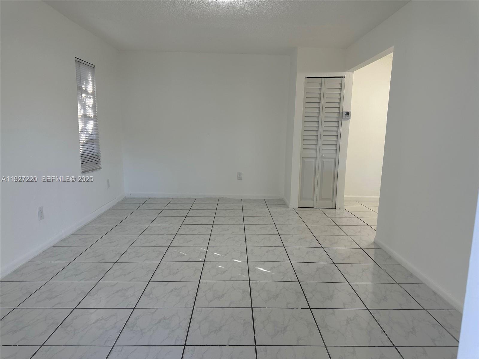 1920 Northwest 4th Street, Unit B Miami, FL 33125 - Photo 14 of 14 an empty room with white walls and tiles