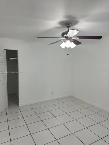 a very nice looking room with a fan and a chandelier fan