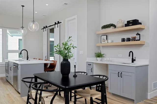 a view of a dining room with a table and chairs in it