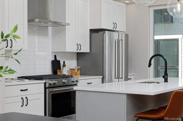 a kitchen with stainless steel appliances a sink and a stove