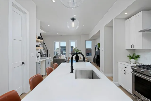 a kitchen with stainless steel appliances kitchen island granite countertop a refrigerator and a stove top oven