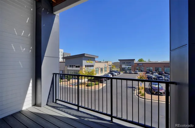 a view of a balcony with wooden floor and city view