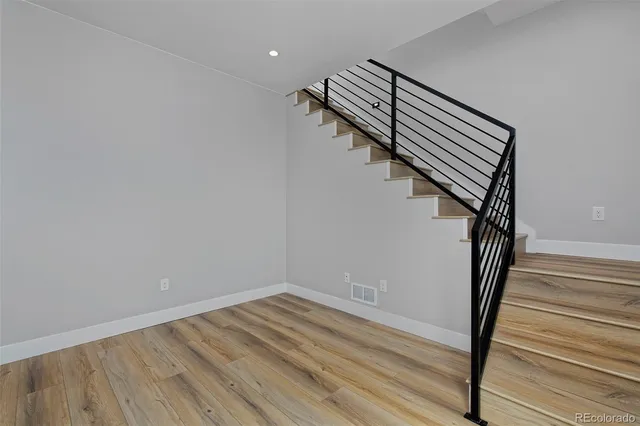 a view of entryway and hall with wooden floor