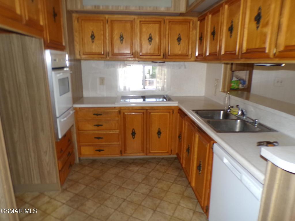250 East Telegraph Road, Unit 220 Fillmore, CA 93015 - Photo 11 of 24 a kitchen with granite countertop a sink and cabinets