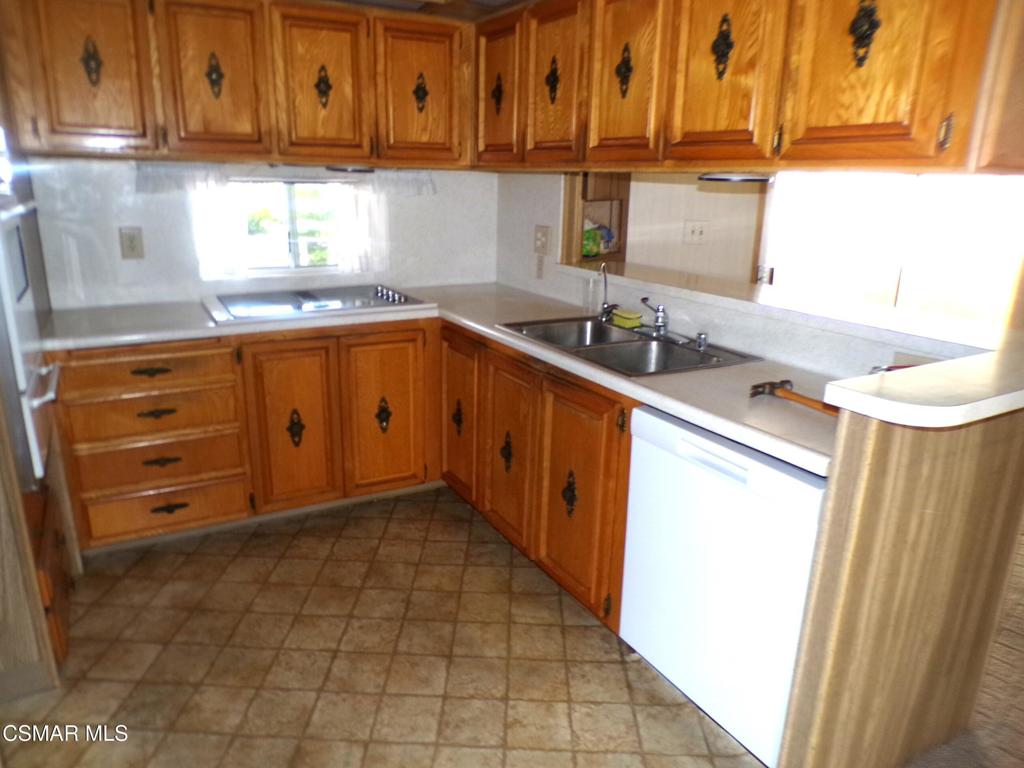 250 East Telegraph Road, Unit 220 Fillmore, CA 93015 - Photo 12 of 24 a kitchen with granite countertop a sink a stove and cabinets