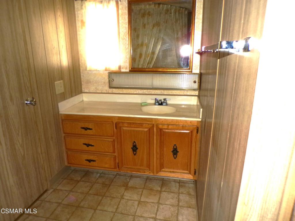 250 East Telegraph Road, Unit 220 Fillmore, CA 93015 - Photo 21 of 24 a bathroom with a sink vanity and mirror