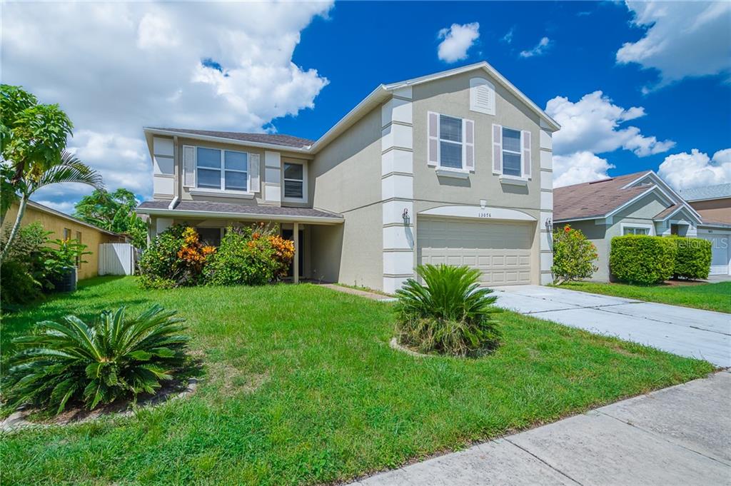 13076 Ruidosa Loop Orlando, FL 32837 - Photo 1 of 1 a front view of a house with a garden