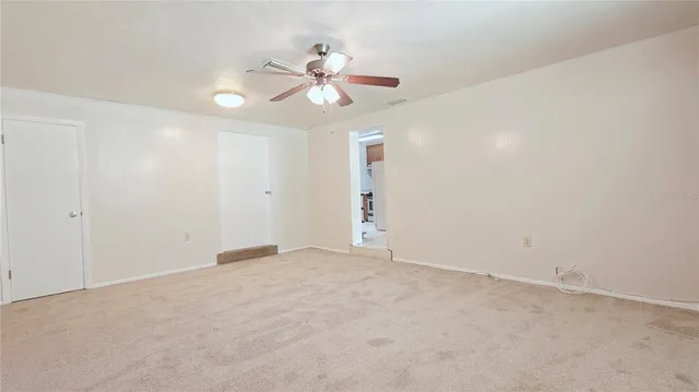 a view of an empty room with a fan