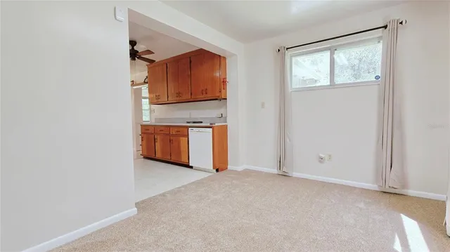 a view of a kitchen with wooden floor and a sink
