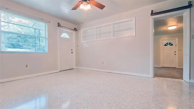 an empty room with windows and closet