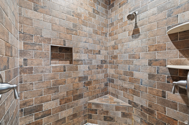 1930 Crimson Road Kanab, UT 84741 - Photo 16 of 42 Tiled shower surround with a built-in corner bench, recessed niche, and wall-mounted showerhead