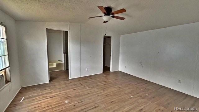 1212 Reed Lane La Junta, CO 81050 - Photo 13 of 23 a view of empty room with wooden floor and fan