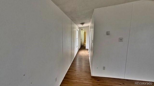 1212 Reed Lane La Junta, CO 81050 - Photo 17 of 23 a view of a hallway with wooden floor