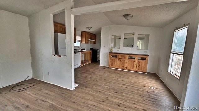 1212 Reed Lane La Junta, CO 81050 - Photo 6 of 23 a view of a hallway with wooden floor and a kitchen
