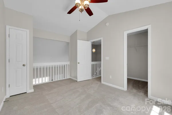 a view of a livingroom with a ceiling fan and entryway
