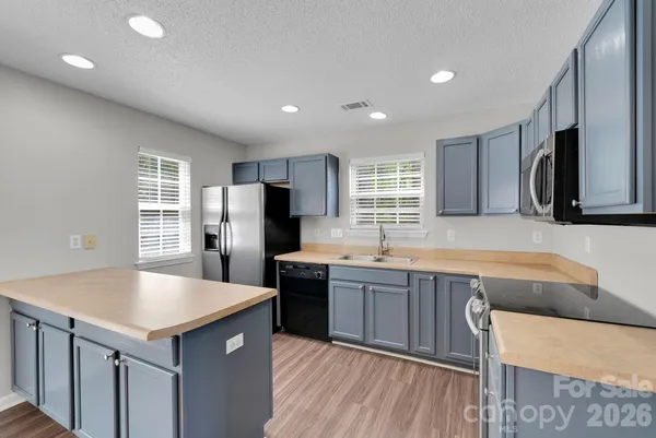 a kitchen with center island and stainless steel appliances