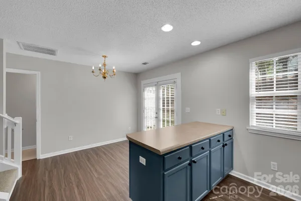 a kitchen with sink cabinets and wooden floor