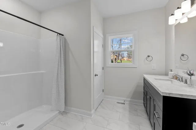 a bathroom with a double vanity sink mirror and