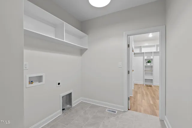 a view of room with window and wooden floor