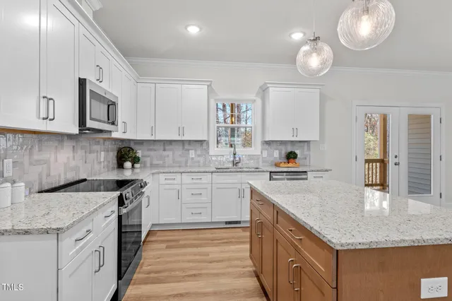 a front view of a house with a garden and yard