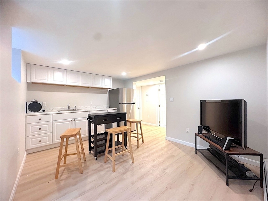 a view of a workspace with furniture and wooden floor