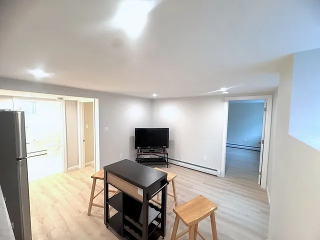 a view of a livingroom with furniture and a flat screen tv