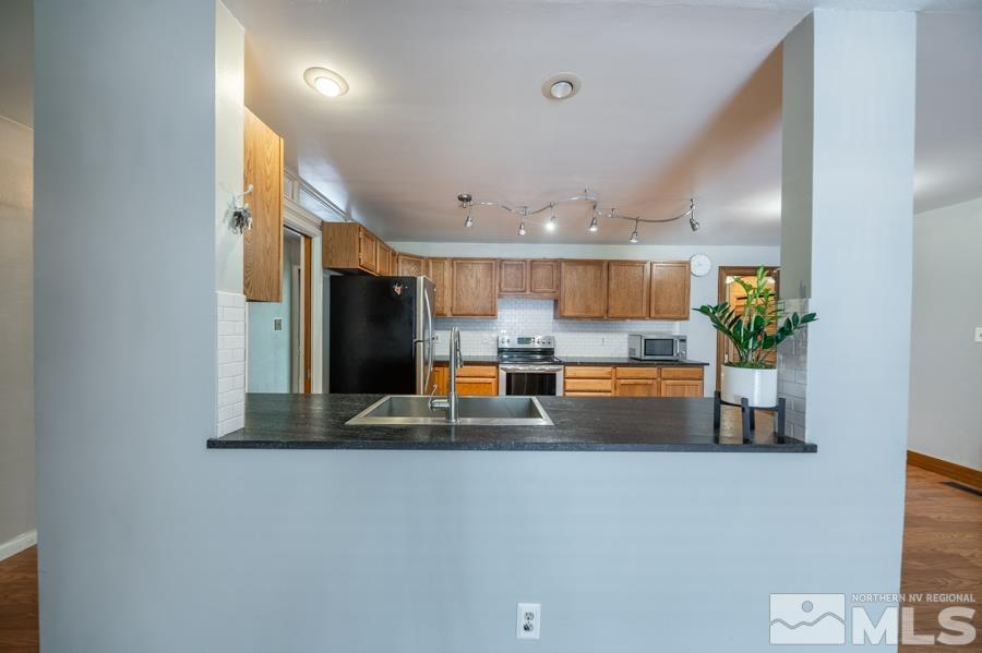 930 Tamarack Drive Reno, NV 89509 - Photo 8 of 31 a view of kitchen with stainless steel appliances wooden floor and chair