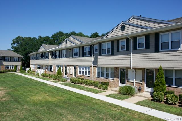 a front view of a house with a yard table and chairs