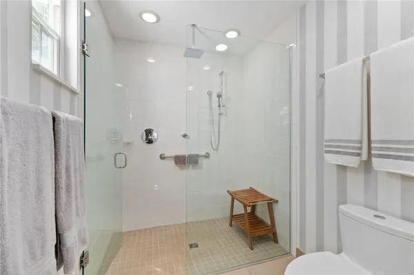 a bathroom with a shower a toilet and a sink
