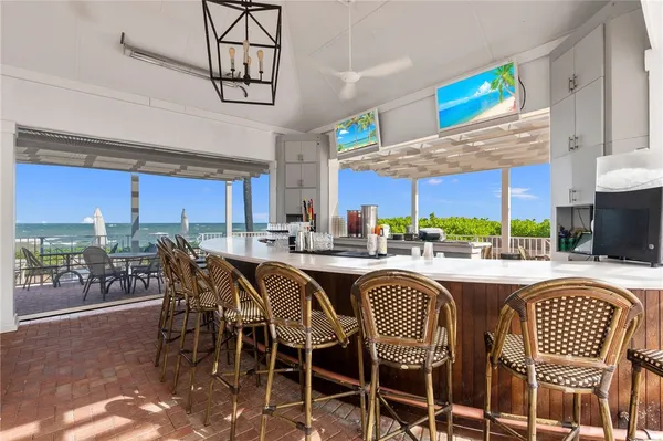 a kitchen with a dining table chairs sink and cabinets