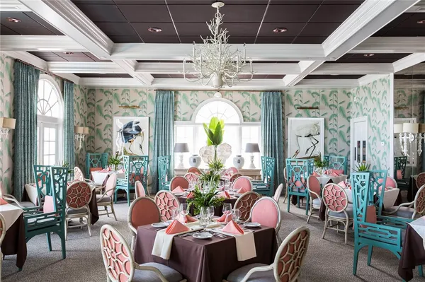 a dining room with furniture a chandelier and a rug