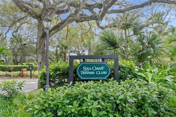 a sign that is sitting on a brick wall