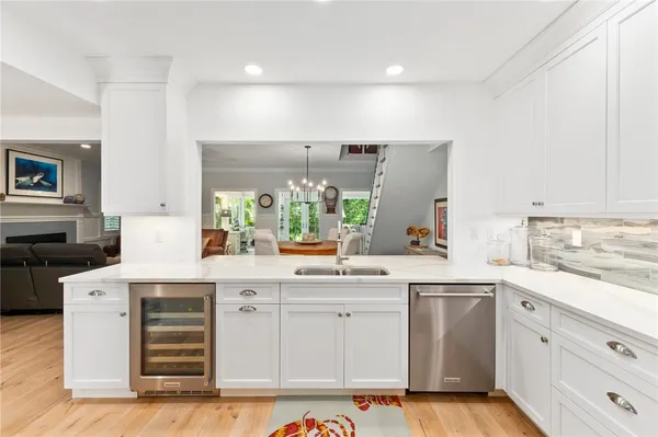 a kitchen with a sink window and cabinets