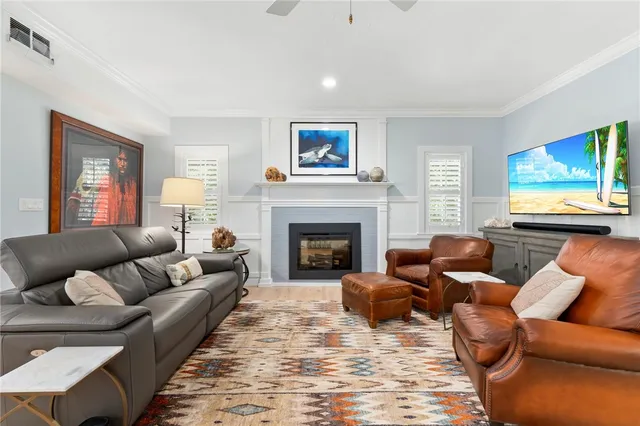 a living room with furniture a large window and a fireplace