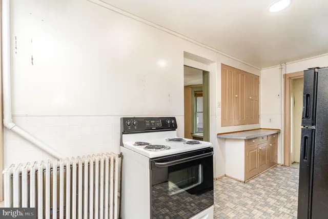 a kitchen with a stove and a refrigerator