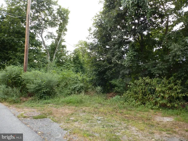 a front view of a house with a yard table and chairs