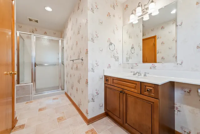 a bathroom with a sink a mirror and a shower