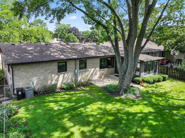 a view of house with backyard