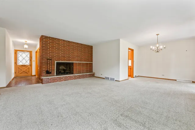 an empty room with fireplace and fan