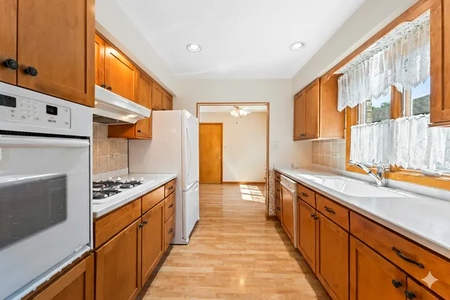 a kitchen with stainless steel appliances a sink and cabinets